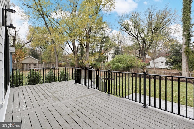 wooden terrace featuring a yard