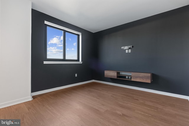 spare room with hardwood / wood-style flooring