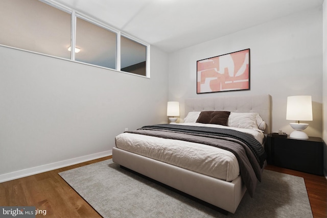 bedroom with dark hardwood / wood-style floors