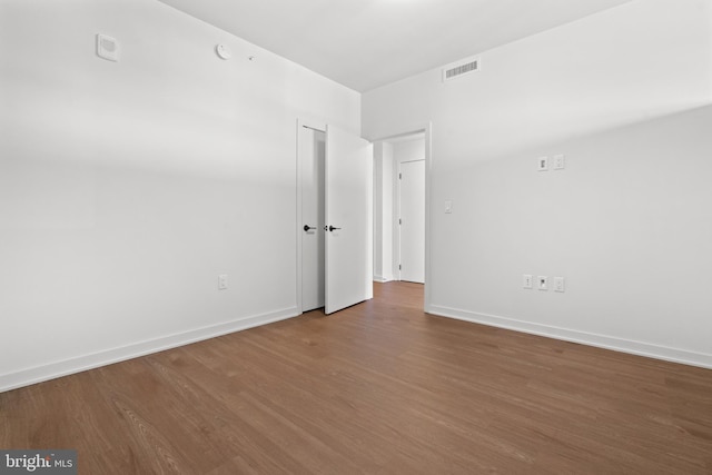 unfurnished room with wood-type flooring