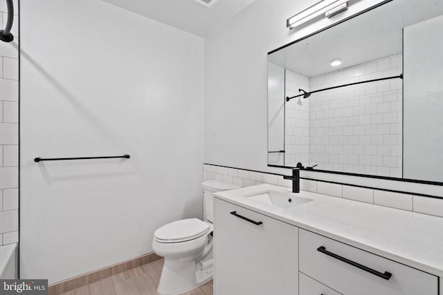 bathroom featuring vanity, hardwood / wood-style flooring, and toilet