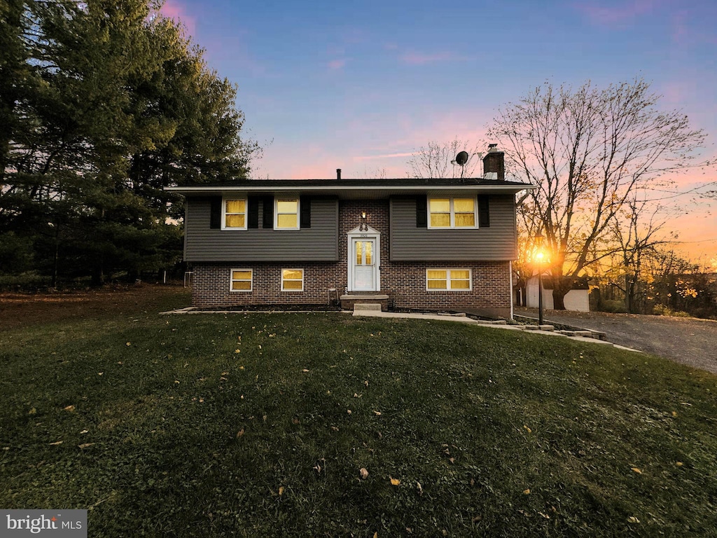 bi-level home with a lawn