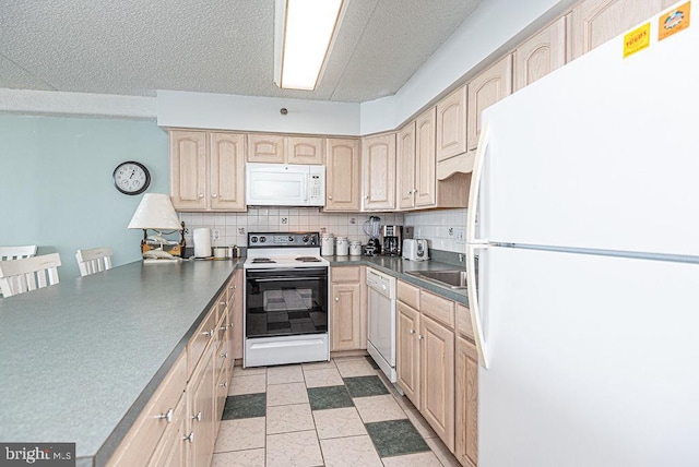 kitchen with white appliances, a kitchen breakfast bar, light tile patterned floors, light brown cabinetry, and tasteful backsplash