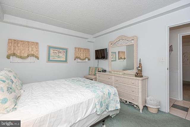 carpeted bedroom with a textured ceiling