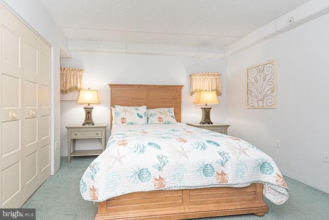 bedroom featuring carpet flooring, beam ceiling, a textured ceiling, and a closet