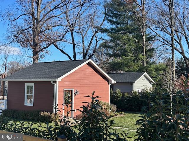 view of side of home with a yard