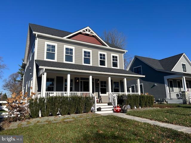 view of front of home with a front yard and a porch