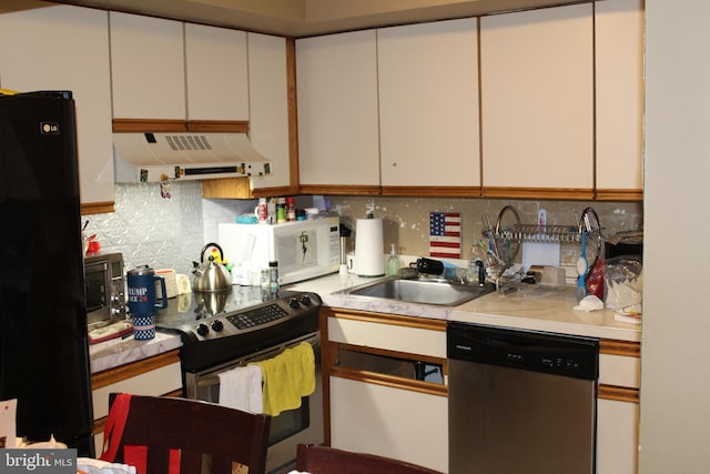 kitchen featuring backsplash, white cabinets, stainless steel appliances, and ventilation hood