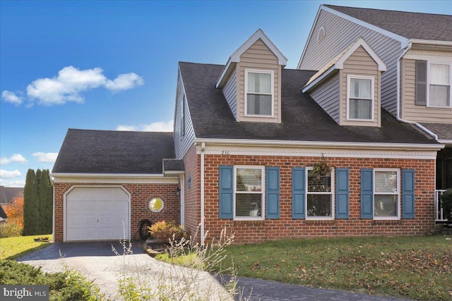 view of front of house featuring a front yard and a garage