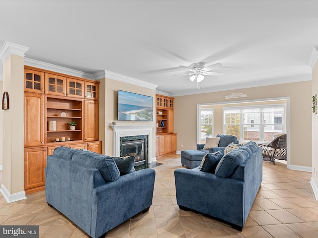 tiled living room with ceiling fan, crown molding, a high end fireplace, and built in shelves