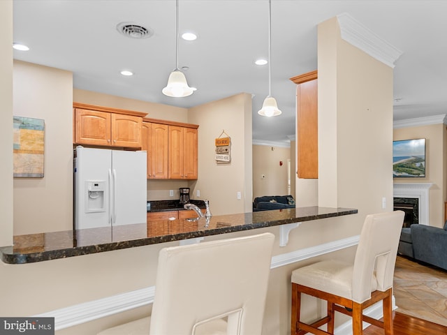 kitchen with white fridge with ice dispenser, ornamental molding, a premium fireplace, light hardwood / wood-style floors, and kitchen peninsula