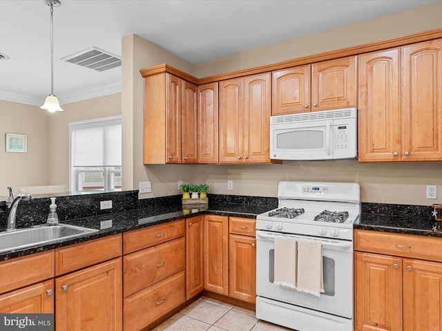 kitchen featuring white appliances, sink, decorative light fixtures, dark stone countertops, and light tile patterned flooring