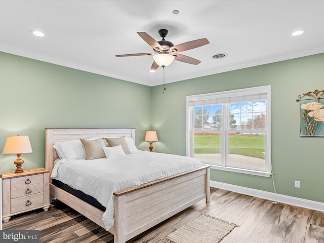 bedroom with ceiling fan, wood-type flooring, and ornamental molding