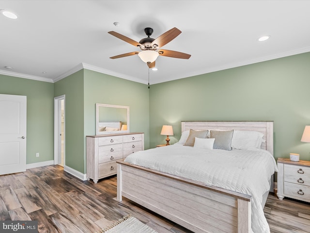 bedroom featuring ceiling fan, dark hardwood / wood-style floors, and ornamental molding