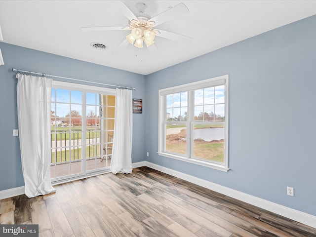 empty room with hardwood / wood-style flooring and ceiling fan