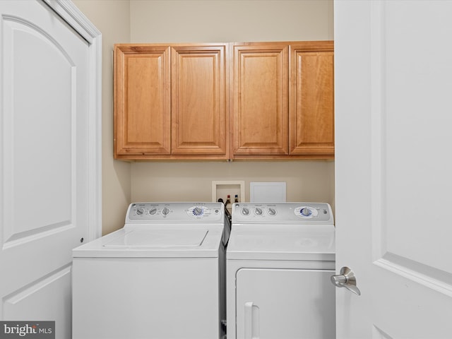 washroom with cabinets and independent washer and dryer