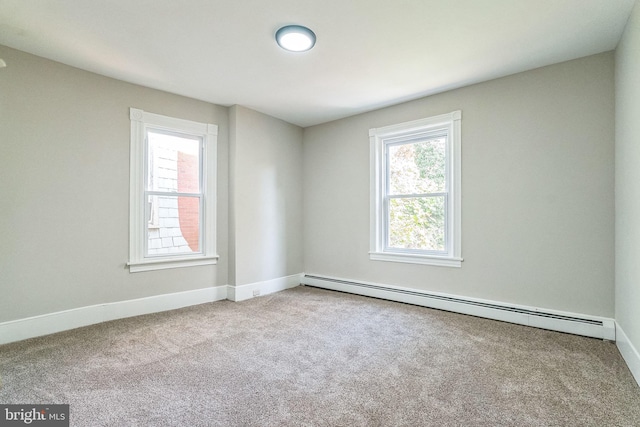 unfurnished room featuring light carpet and a baseboard radiator