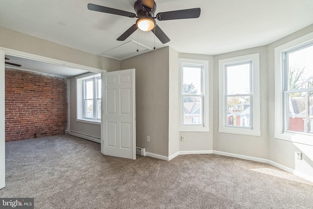 interior space featuring ceiling fan, light colored carpet, baseboard heating, and brick wall