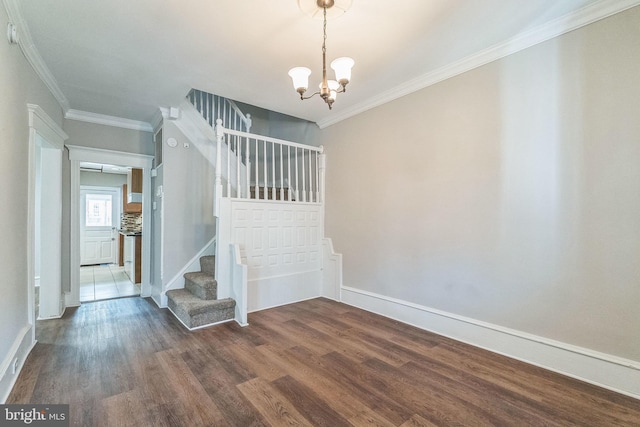 stairway with hardwood / wood-style flooring, ornamental molding, and an inviting chandelier