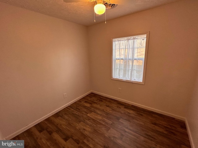 spare room featuring ceiling fan, dark hardwood / wood-style flooring, and a textured ceiling