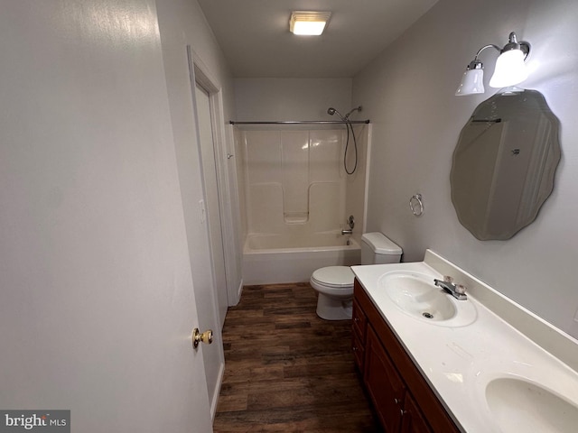 full bathroom featuring shower / bathing tub combination, wood-type flooring, vanity, and toilet