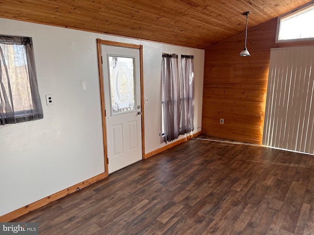 foyer with wooden walls, vaulted ceiling, dark wood-type flooring, and wood ceiling