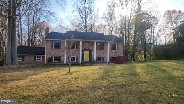 split foyer home with central air condition unit and a front lawn