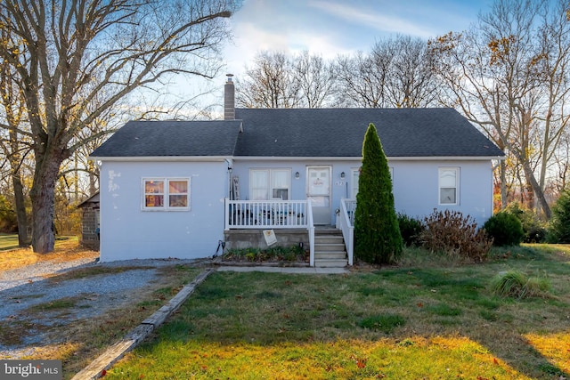 view of front facade with a front lawn and a porch