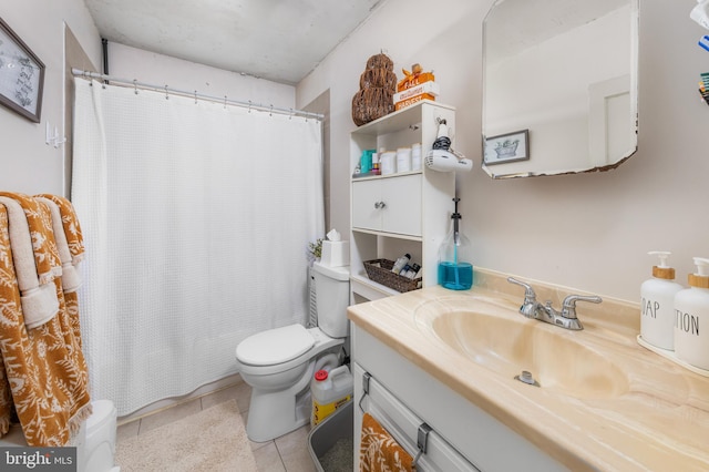 bathroom featuring tile patterned floors, vanity, and toilet