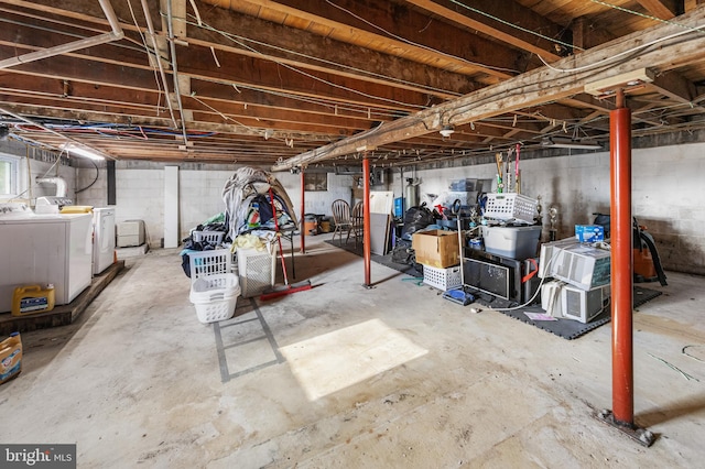 basement featuring white refrigerator and washing machine and clothes dryer