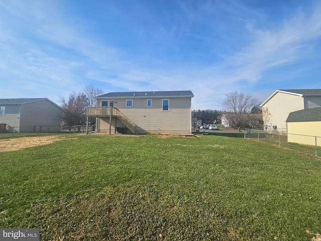 back of house with a yard and a wooden deck