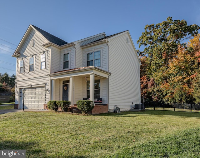 view of property featuring a front yard, central AC, and a garage