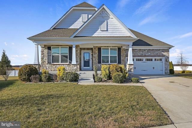 craftsman-style house featuring a garage, a front lawn, and a porch