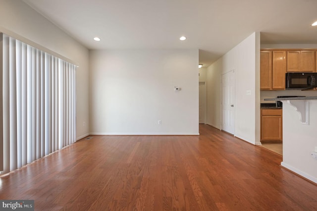 unfurnished living room with hardwood / wood-style flooring