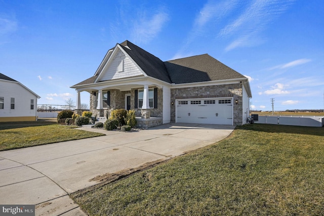 craftsman-style house featuring a garage, a front yard, and covered porch