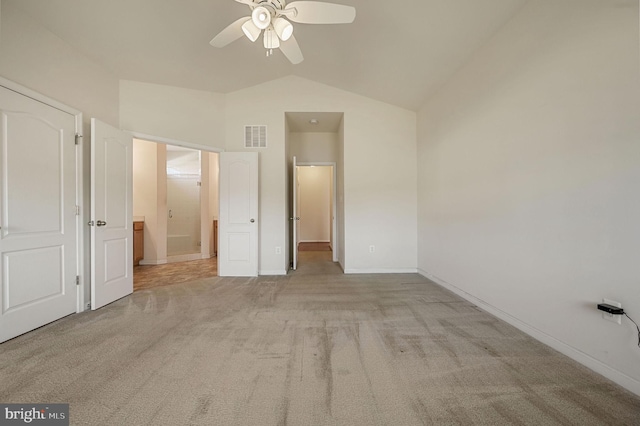 unfurnished bedroom with light carpet, ensuite bath, lofted ceiling, and ceiling fan