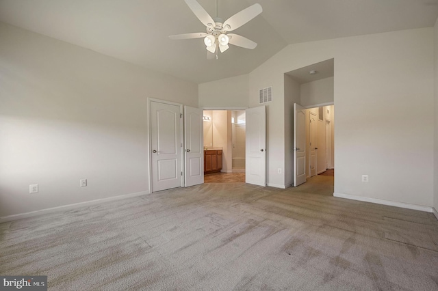 unfurnished bedroom with light colored carpet, connected bathroom, and high vaulted ceiling