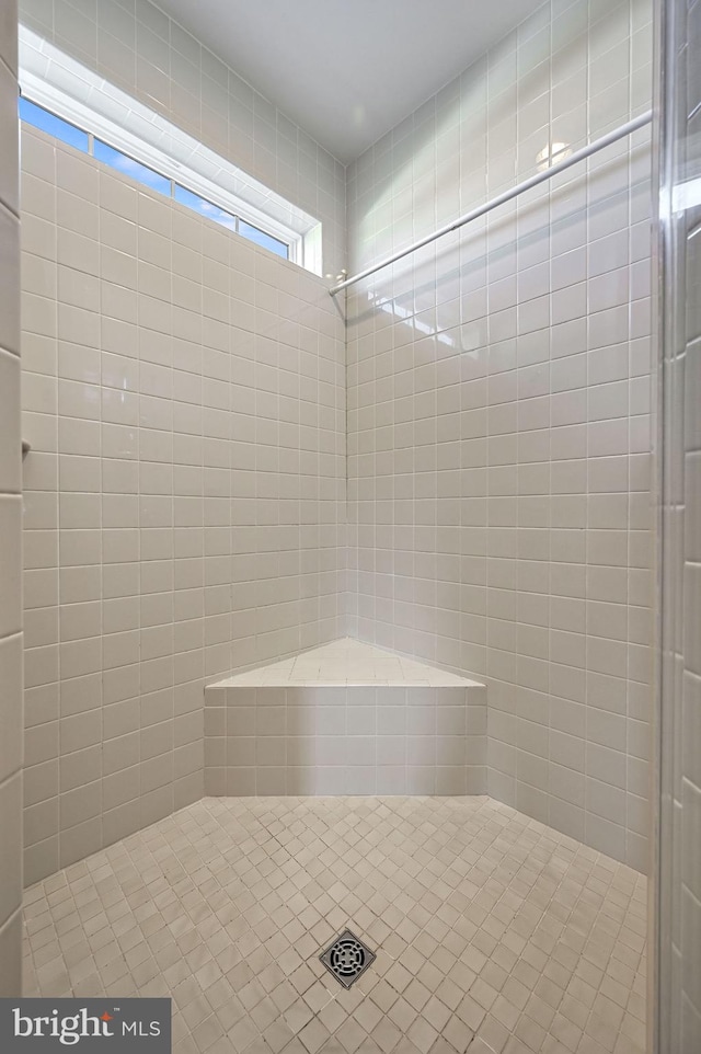 bathroom with tiled shower