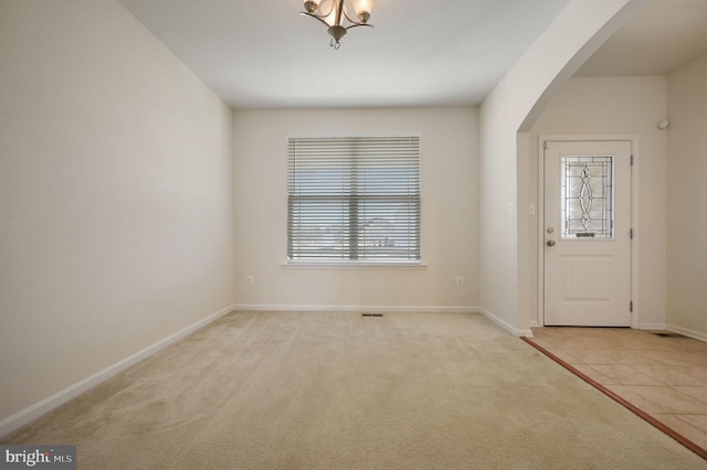 view of carpeted foyer entrance