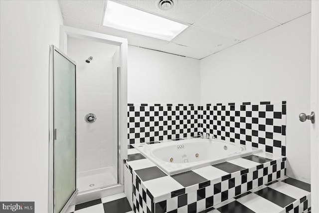 bathroom featuring a drop ceiling and plus walk in shower