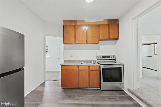 kitchen featuring sink, stainless steel appliances, and dark hardwood / wood-style floors