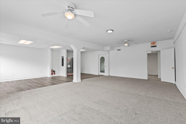 unfurnished living room featuring ceiling fan and hardwood / wood-style floors