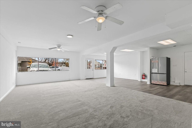 unfurnished living room with ceiling fan and carpet floors