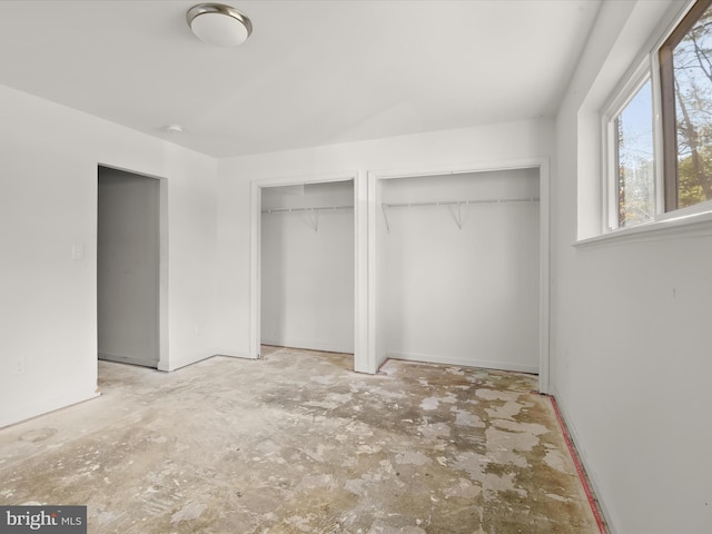 unfurnished bedroom with multiple closets