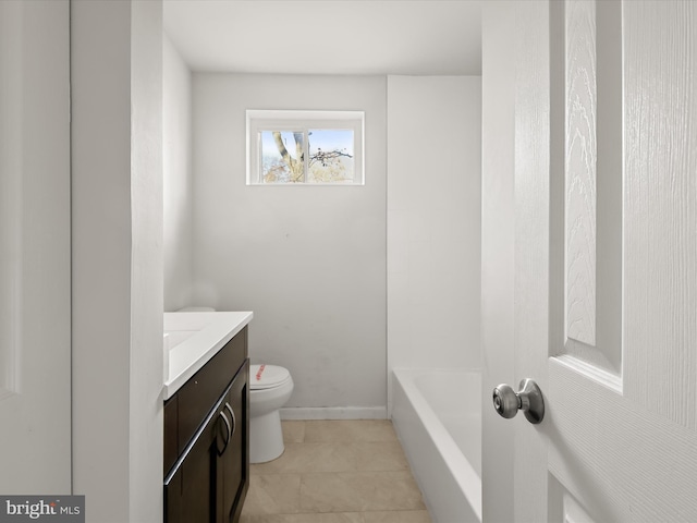 bathroom with toilet, vanity, tile patterned floors, and a bathing tub