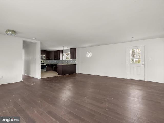 unfurnished living room with dark hardwood / wood-style floors