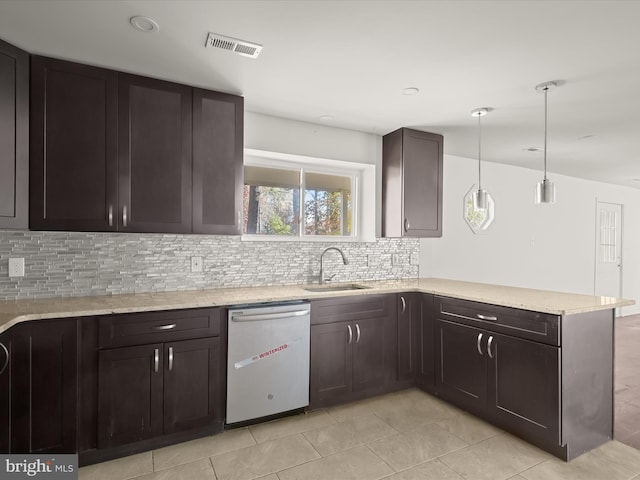 kitchen with decorative backsplash, dishwasher, pendant lighting, and sink