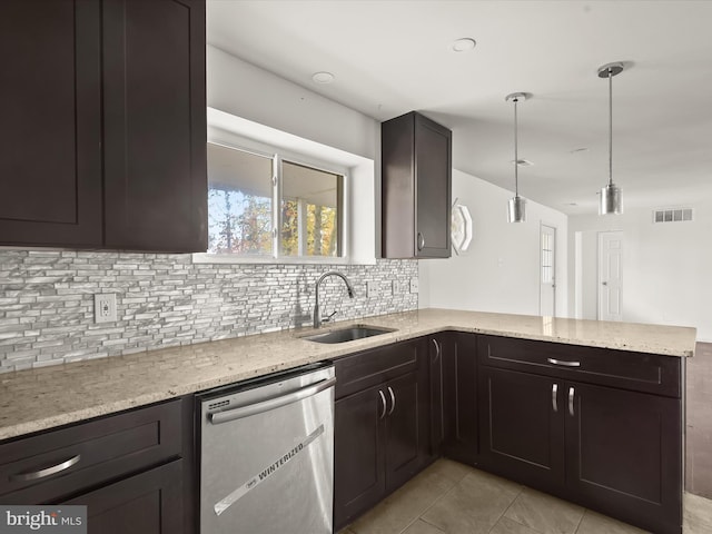 kitchen featuring sink, tasteful backsplash, stainless steel dishwasher, kitchen peninsula, and pendant lighting