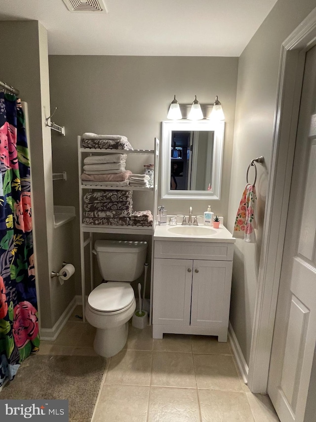 bathroom featuring tile patterned flooring, vanity, and toilet