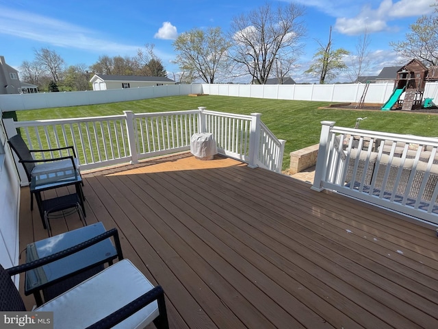 wooden deck with a yard and a playground